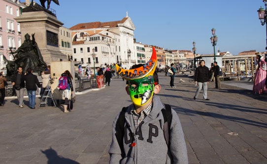 Boy Walking Around Venice in a Mask