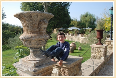 boy-in-garden-at-borgo-santo-pietro-tuscany-italy