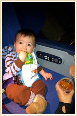 baby eating on airplane
