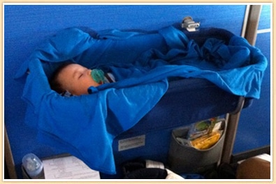baby sleeping in bulkhead bassinet