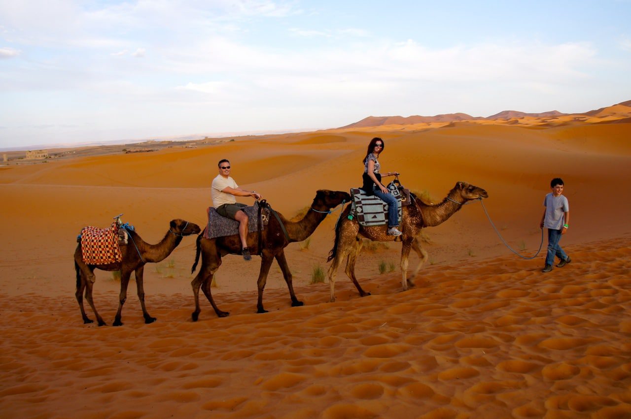 Family Riding Camels in Sahara Desert Morocco