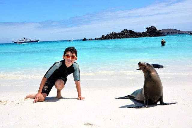 kid with galapagos sea lion