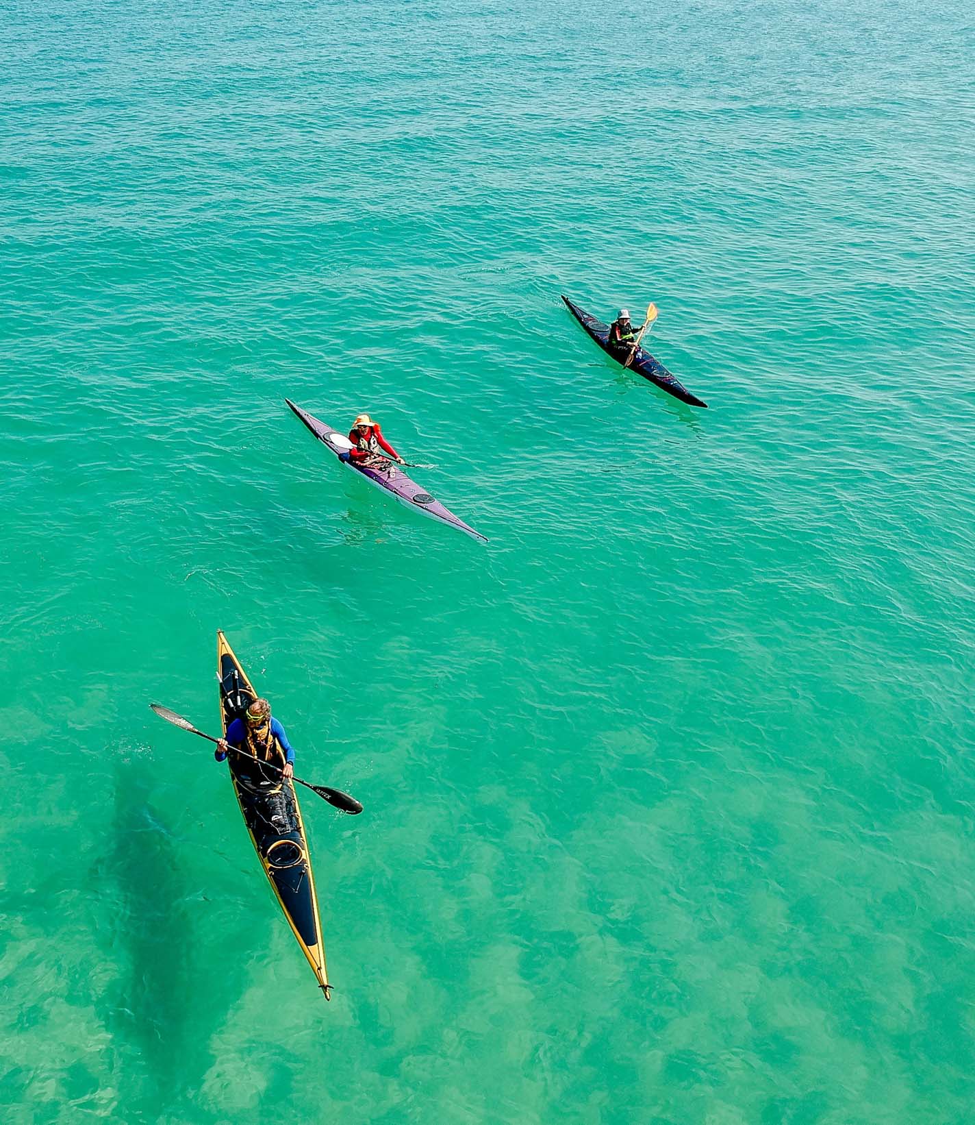 Three people sea kayaking in Greece