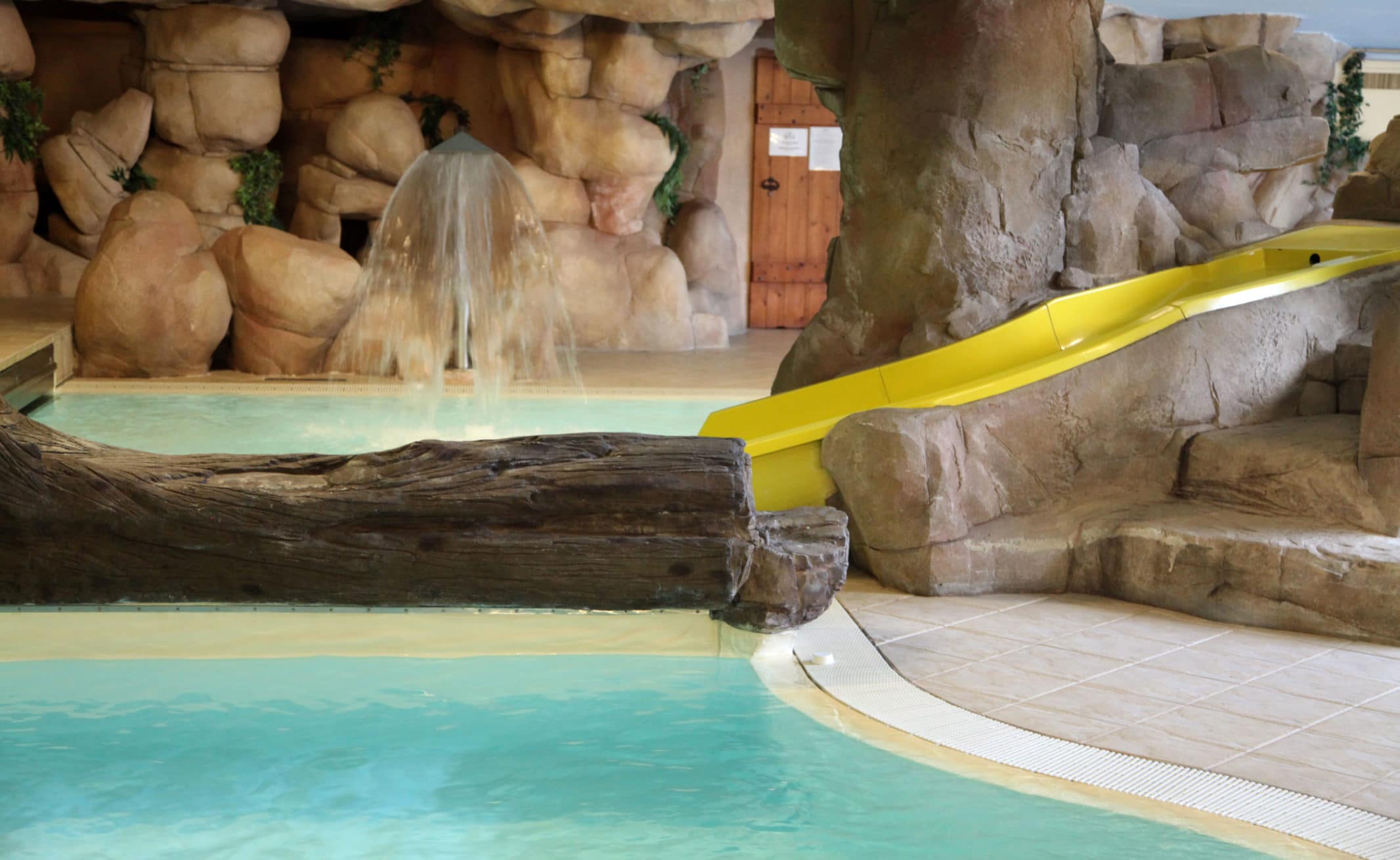 Indoor pool area with children's slide