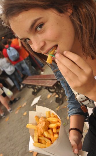 girl eating fries in brussels