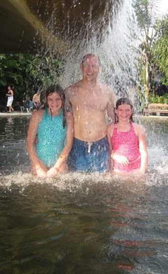 family-under-waterfall-in-costa-rica
