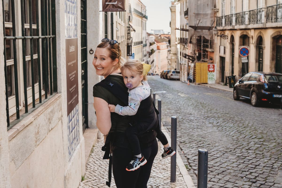 Woman uses baby carrier in Lisbon