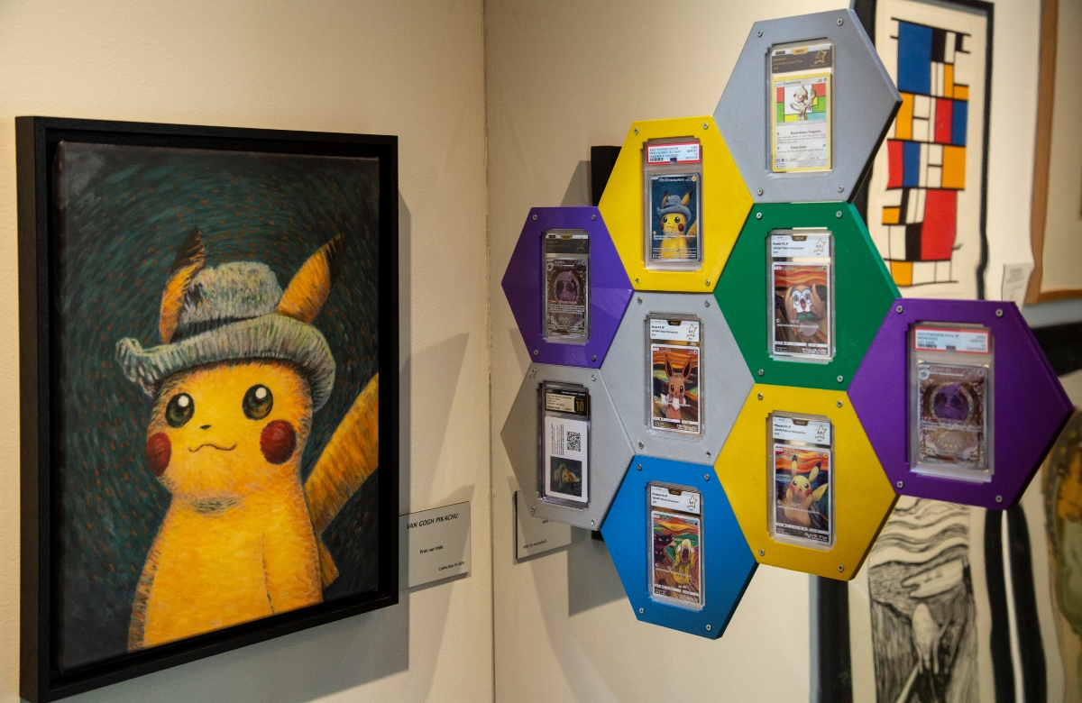 A framed painting of Pikachu wearing a gray felt hat, rendered in swirling Van Gogh–style brushstrokes, hangs on a gallery wall beside a label reading "Van Gogh Pikachu." To the right, a honeycomb-shaped wall display of colorful hexagons holds graded Pokémon trading cards featuring art-inspired designs, including Pikachu and other characters posed like Edvard Munch's The Scream, with Mondrian-style and Munch-inspired artworks visible in the background.